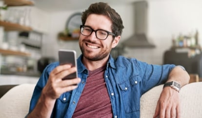 Man on couch with phone in hand
