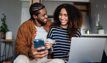 Two friends online shopping with their Walmart MoneyCard